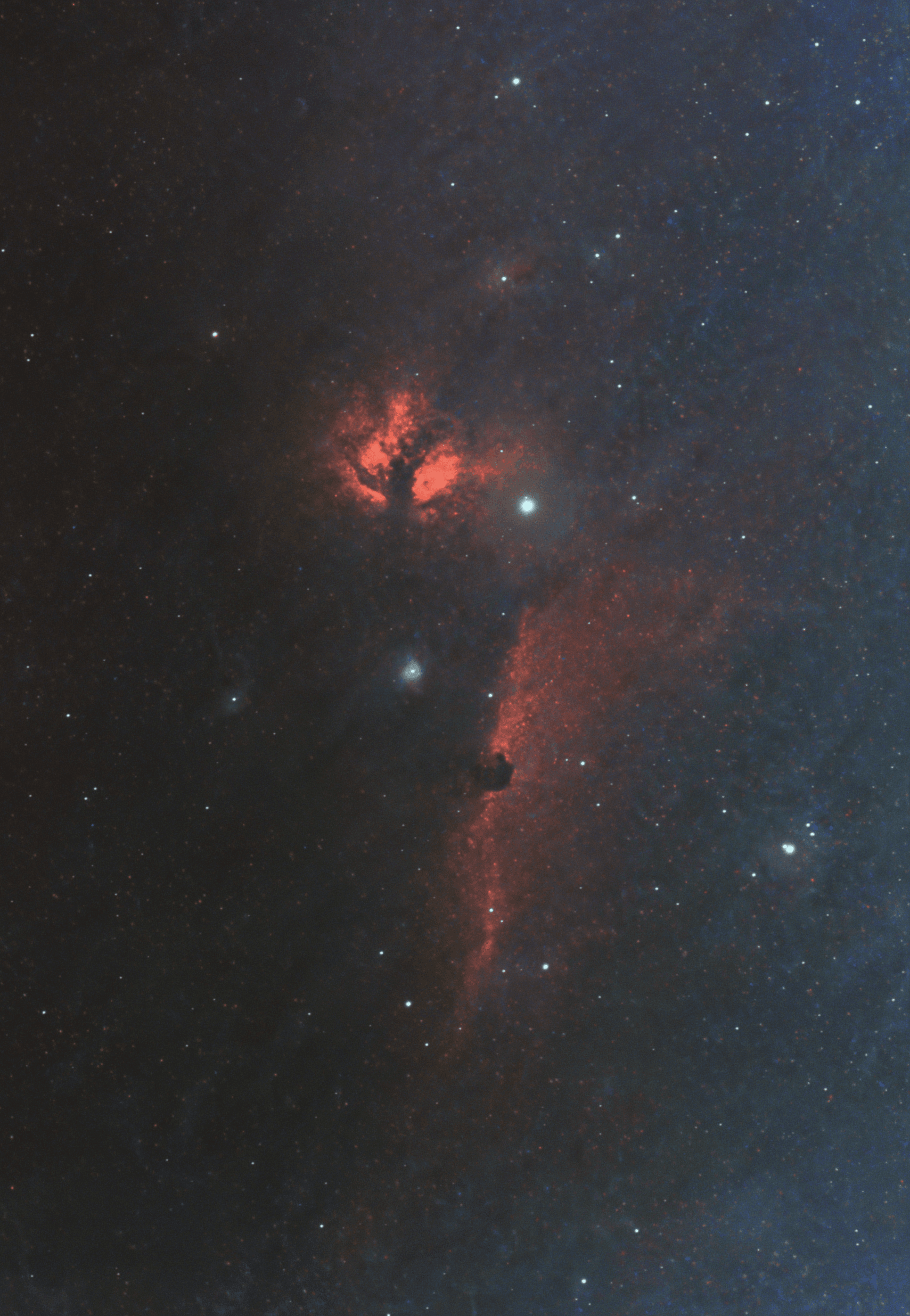 Astrophotography image of the Flame Nebula showing glowing red and orange hydrogen emission against a dark star field.